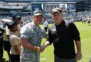 Kelly greets a soldier prior to the start of Military Appreciation Day at Eagles Training Camp last summer