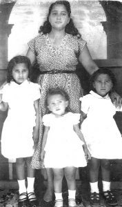Young Gloria with her sisters and mother Nuncia Bonilla