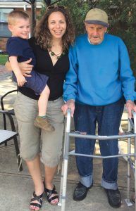 Rachel Howe, holding her son Eli, often speaks with her grandfather Karol Strender about his Holocaust memories