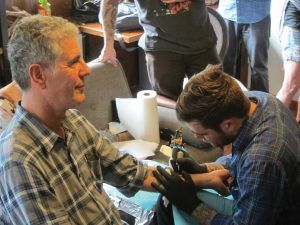 : Earlier in his career, Bourdain got a tattoo in Texas for the Travel Channel’s “No Reservations” 