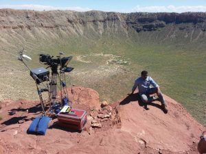 Host Neil DeGrasse Tyson sits at the edge of Meteor Crater, what was left when an asteroid traveling 26,000 mph crashed into Earth 
