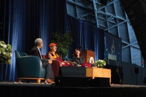 Interpreter Thupten Jinpa, the Dalai Lama and Rev. Dr. Alison Boden on stage at Princeton University 