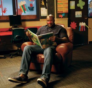 All-star athlete Shaquille O’Neal has no trouble really playing the part at story time 