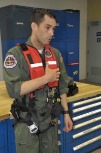 Aviation survival technician Pepe Carire demonstrates the harness rescue swimmers wear 